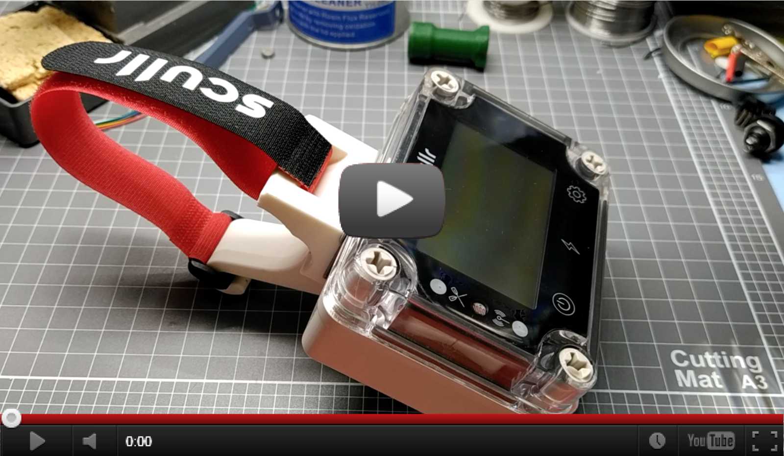 A rower in a single scull with a Scullr GPS rowing computer on an adhesive mount.